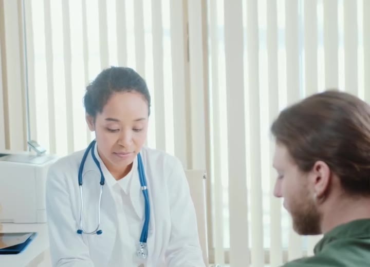 Doctor consulting with a patient about whiplash treatment